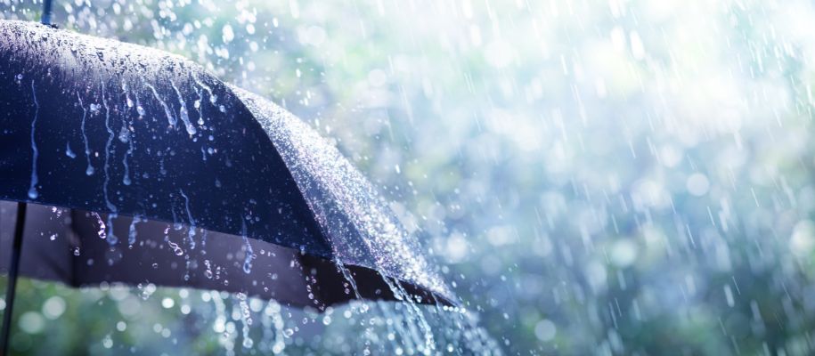 Black umbrella in heavy rain