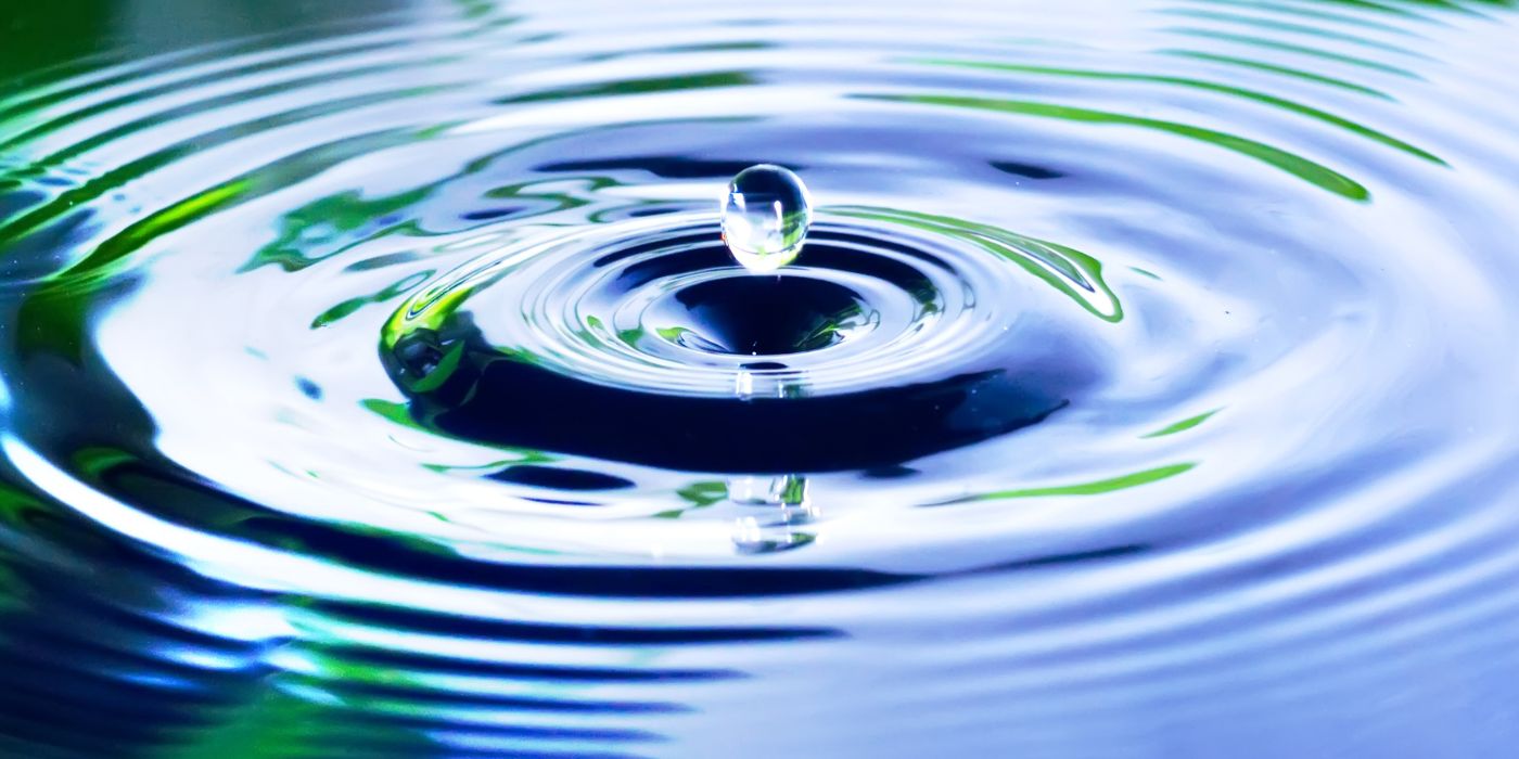 Water droplet causing ripples in pond