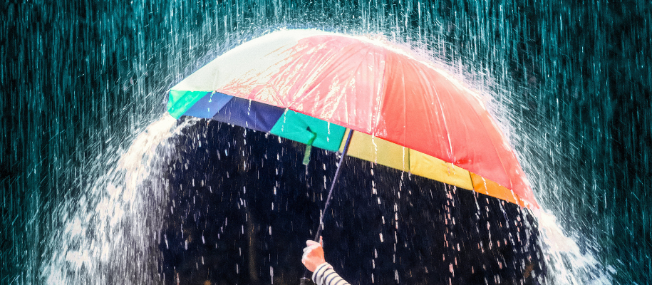 Colorful umbrella in heavy rainstorm