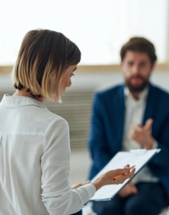 Two people discussing in a professional setting.