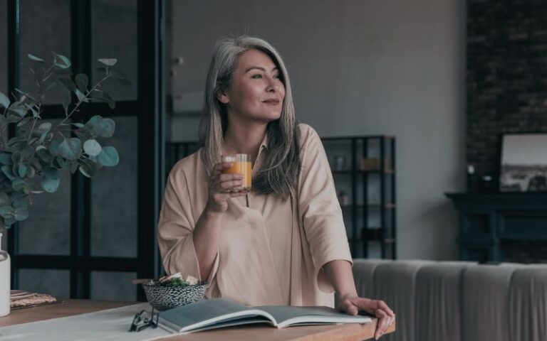 Woman enjoying a drink, reading a book.