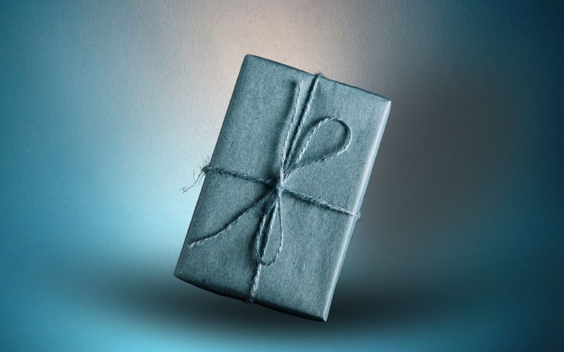 Gift wrapped in blue paper with twine ribbon.